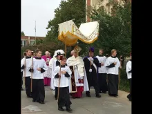 Archbishop Paul Coakley of Oklahoma City carries the Eucharist in procession Sept. 21 to counter a black mass held at the city's civic music hall. 