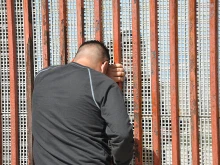 Families meet through border fence. 