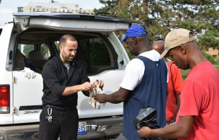 Father Marko Djonovic works with homeless men as part of Better Way Detroit.   Dan Meloy/The Michigan Catholic.