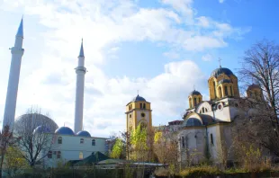 A church and a mosque adjacent one another in Ferizaj, Kosovo.   Valdete Hasani via Wikimedia (CC BY SA 3.0).