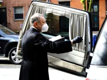 Monsignor Kieran Harrington blesses the coffin of Fr. Jorge Ortiz-Garay before its trip to Mexico. 