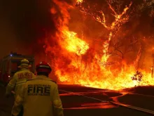 Fire and rescue personnel before a bushfire next to a major road and homes near Bilpin, New South Wales, Dec. 19, 2019. 