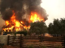 Fire consumes a barn as an out of control wildfire moves through the area in Glen Ellen, Calif., Oct 9, 2017. 