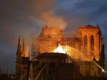 Firefighters douse flames billowing from the roof at Notre-Dame Cathedral in Paris, April 15, 2019. 