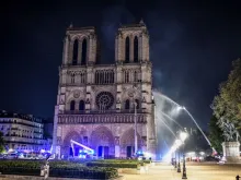Firefighters respond to a major fire at Notre Dame cathedral in Paris, April 15, 2019. 