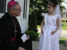 Bishop Thomas J. Tobin greets Sydney Khoury outside the rectory of St. Philip Church, Greenville last week / Photo: Rick Snizek, Rhode Island Catholic