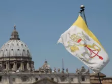 The flag of Vatican City with St. Peter’s Basilica in the background. Credit: Bohumil Petrik/CNA.