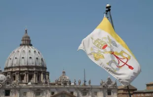 The flag of Vatican City with St. Peter’s Basilica in the background. Credit: Bohumil Petrik/CNA. 