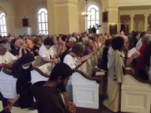 Participants pray at the opening Mass of the 2012 Fortnight for Freedom in Baltimore. 