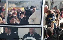 Fr. Fabian Baez (back left) was invited to ride in the back of the popemobile after being spotted by Pope Francis in St. Peter's Square Jan. 8, 2014. ?w=200&h=150
