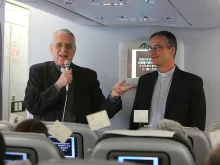 Fr. Federico Lombardi, Holy See press officer, and Msgr. Dario Vigano, prefect of the communications secretariat, aboard the papal flight to Quito, July 5, 2015. 