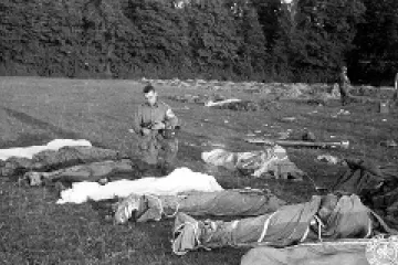 Fr Francis Sampson who was known as the Parachute Padre gives last rites to paratroopers killed in action during the D Day invasion of Normandy Credit US Navy CNA 6 6 