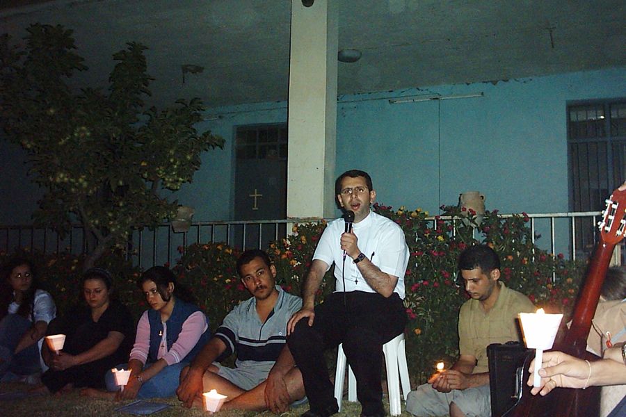 Father Ragheed Aziz Ganni, who was killed for the faith June 3, 2007 in Mosul, is seen with a group of young adults. Photo courtesy of Aid to the Church in Need.?w=200&h=150