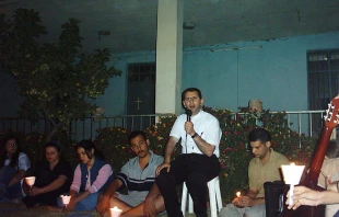 Father Ragheed Aziz Ganni, who was killed for the faith June 3, 2007 in Mosul, is seen with a group of young adults. Photo courtesy of Aid to the Church in Need.