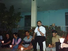 Father Ragheed Aziz Ganni, who was killed for the faith June 3, 2007 in Mosul, is seen with a group of young adults. Photo courtesy of Aid to the Church in Need.