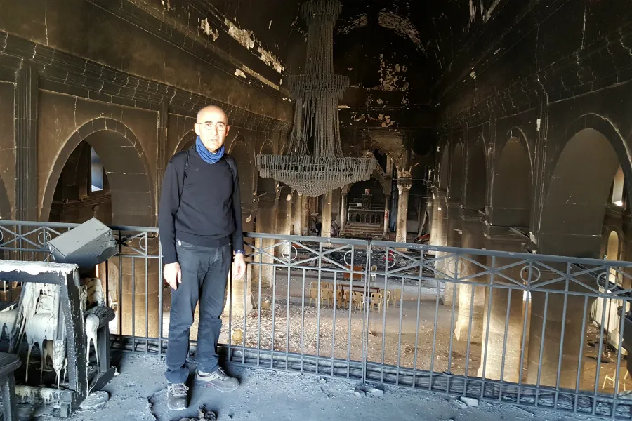 Fr. Georges Jahola in Al-Tahira church in Bakhdida in November 2016, shortly after the town's liberation. Photo courtesy of Fr. Jahola.?w=200&h=150