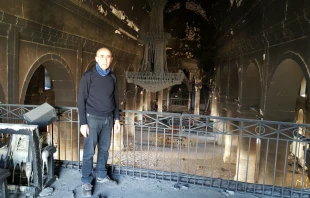 Fr. Georges Jahola in Al-Tahira church in Bakhdida in November 2016, shortly after the town's liberation. Photo courtesy of Fr. Jahola.
