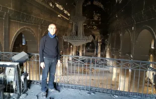 Fr. Georges Jahola in Al-Tahira church in Bakhdida in November 2016, shortly after the town's liberation. Photo courtesy of Fr. Jahola. 