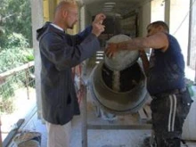 Fr. Jeremias talks to a worker at the building site. 