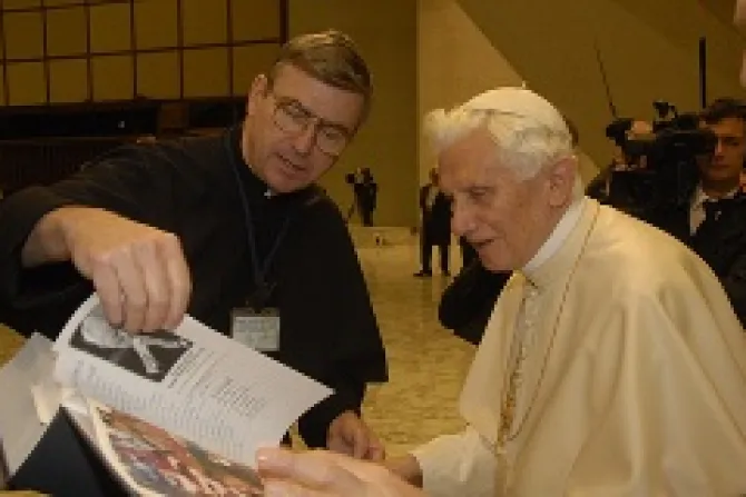Fr John Phalen CSC presents a book with the names of 80000 people who pledged to pray the Rosary daily to the Pope in December Credit Holy Cross Family Ministries CNA 1 4 13