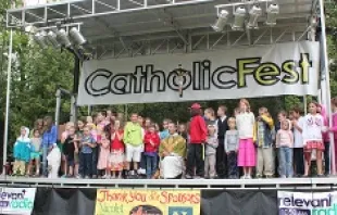 Fr. Quinn Mann, founder of CYE and CatholicFest, invited all the kids to join him on stage and sing a song during the last Mass, July 6, 2014.   Jen Lowery.