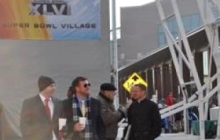 Fr. Rick Nagel of St. John the Evangelist (far right) on the street before Superbowl XLVI.   Breanna Holder