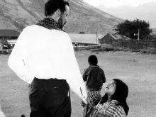 Blessed Stanley Rother and a child in Guatemala. 