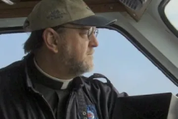 Fr Sinclair Oubre JCL on a boat CNA US Catholic News 8 30 12