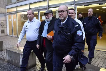 French former priest accused on sexual assaults Bernard Preynat 2nd L leaves Lyons courthouse Jan 17 2020 at the end of his trial Credit Philippe Desmazes AFP via Getty Images