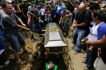 Friends and relatives bury the body of Gerald Vasquez shot dead during clashes with riot police in Divine Mercy church in Managua July 16 2018 Credit INTI OCON AFP Getty Images