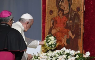 Pope Francis places a bouquet before a Marian icon in Piazza Armerina, central Sicily, Sept. 15, 2018.   AFP via Getty Images
