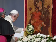 Pope Francis places a bouquet before a Marian icon in Piazza Armerina, central Sicily, Sept. 15, 2018. 