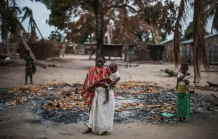 A woman stands in a burned out area after an extremist attack on the village of Aldeia da Paz, Mozambique, Aug. 24, 2019.   AFP via Getty Images.