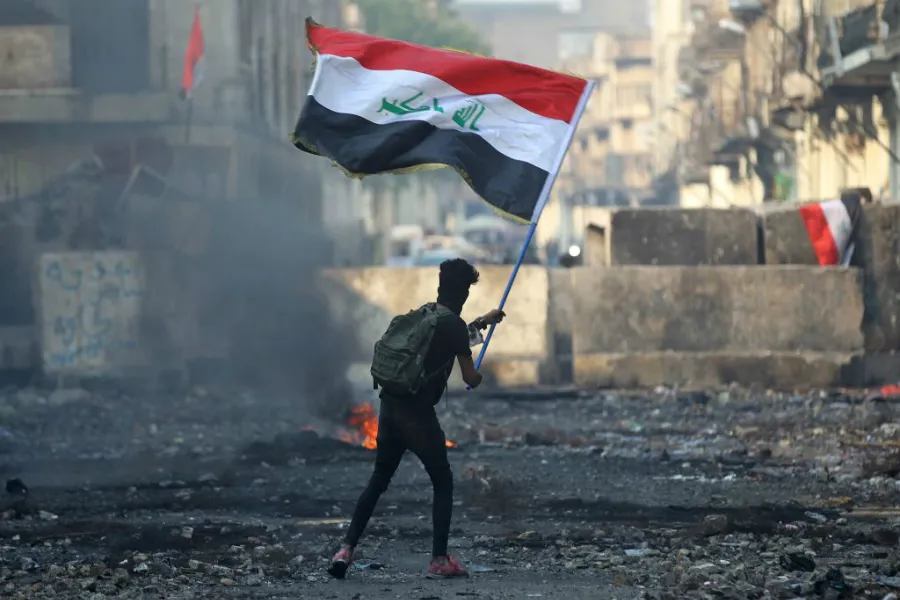 An Iraqi anti-government protester waves a national flag in Baghdad on Nov. 29, 2019. ?w=200&h=150