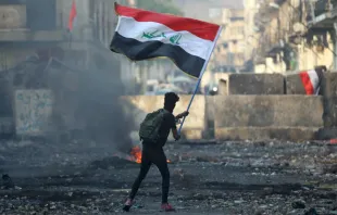 An Iraqi anti-government protester waves a national flag in Baghdad on Nov. 29, 2019.   AFP via Getty Images  