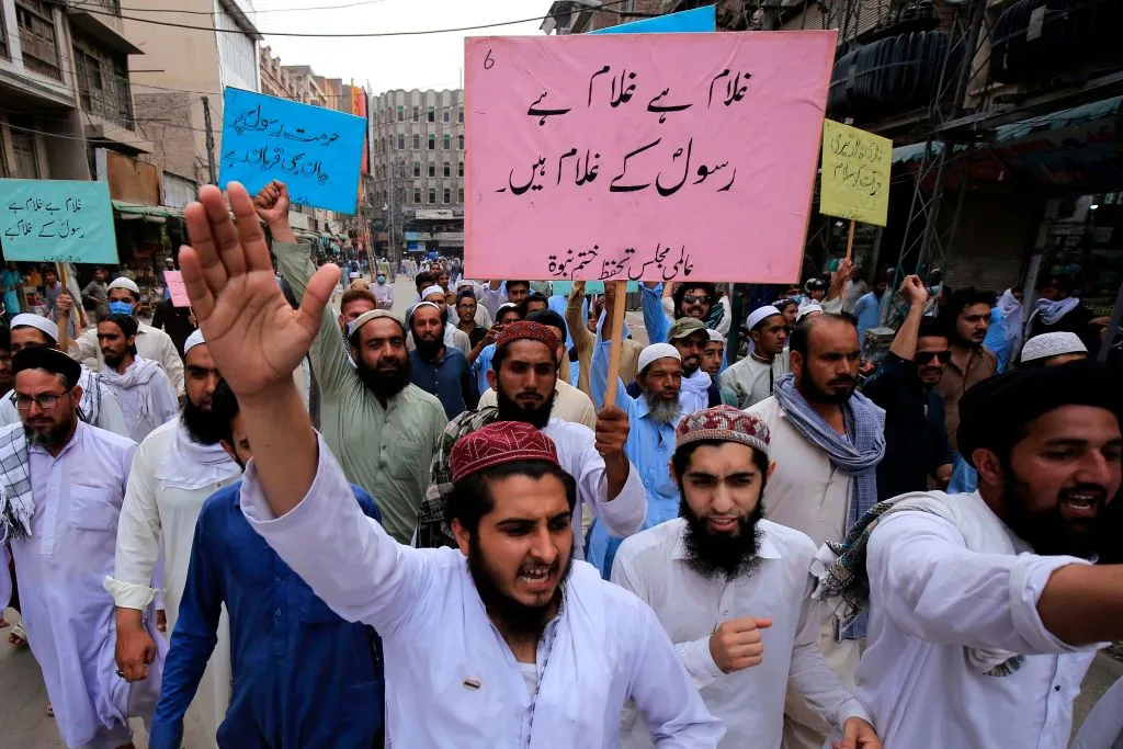 Supporters of a religious group march during a rally in support of Khalid Khan, who killed a man accused of blasphemy, in Peshawar, July 31, 2020. ?w=200&h=150