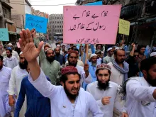 Supporters of a religious group march during a rally in support of Khalid Khan, who killed a man accused of blasphemy, in Peshawar, July 31, 2020. 