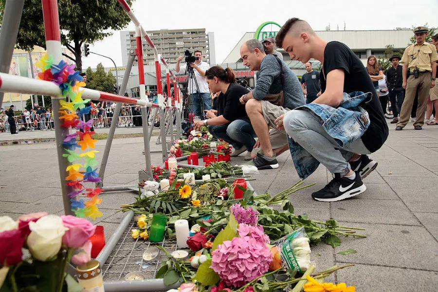 Mourners in Munich after a July 22, 2016 shooting spree at the Olympia Mall. ?w=200&h=150