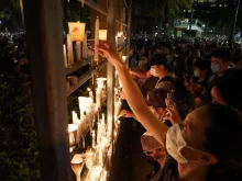 People light candles as they attend a vigil in Victoria Park in Hong Kong on June 4, 2020. 