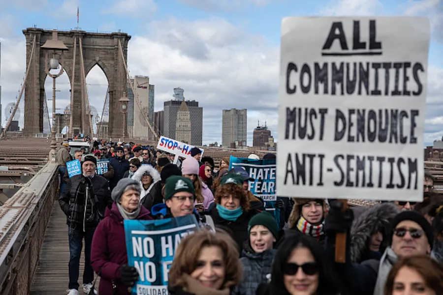 People participate in a Jewish solidarity march across the Brooklyn Bridge on Jan. 5, 2020, in New York City.?w=200&h=150