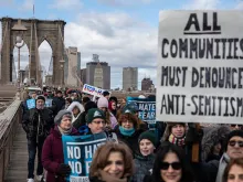 People participate in a Jewish solidarity march across the Brooklyn Bridge on Jan. 5, 2020, in New York City.