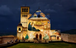 Giotto’s Nativity is projected on the facade of the Basilica of St. Francis of Assisi.   Diocese of Assisi-Nocera Umbra-Gualdo Tadino.