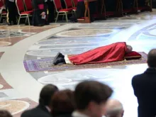 Pope Francis prostrates himself before the altar of St. Peter's Basilica at the opening of the Good Friday liturgy, March 25, 2016. 