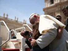 Grazia, a girl with Down syndrome, hugs Pope Francis at General Audience on May 13 2015. 