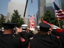 Emergency personnel salute at a Ground Zero ceremony. 