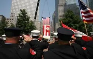 Emergency personnel salute at a Ground Zero ceremony.   911memorial.org
