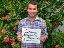Gustavo Adolfo Franco Picaza of Maracaibo, Venezuela holds a sign with his gratitude for winning the contest. 