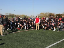 Catholic University of America Head Football Coach Mike Gutelius with the Catholic University Cardinals. Credit: Catholic University football team.