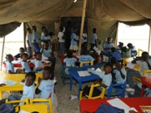Haitian children attend school in a makeshift shelter