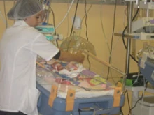 A nurse cares for an infant at Holy Family Hospital